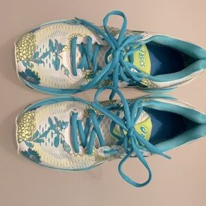 These ASICS sneakers are a size six and used! They are white w/ colorful designs